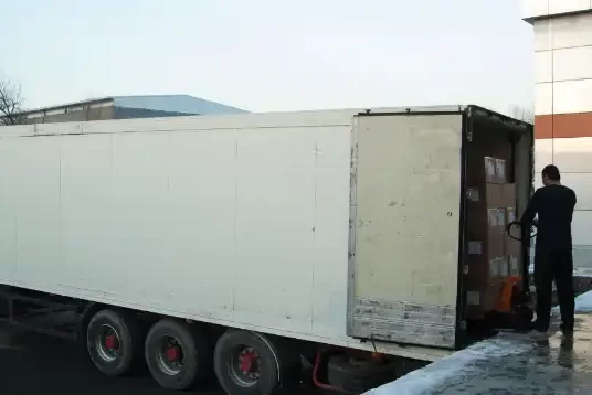 Man Unloading Product from Reefer Trailer